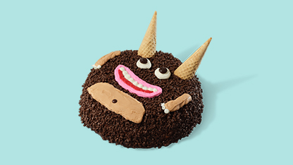 Donut decorated with chocolate frosting, a goofy face, and three ice cream cones.