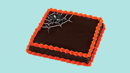 This is an image of a cake with the word "birthday" written on top of it. The cake has red frosting and appears to have a chocolate layer underneath.