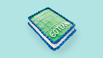 A rectangular cake decorated to resemble an open book with pages inside.